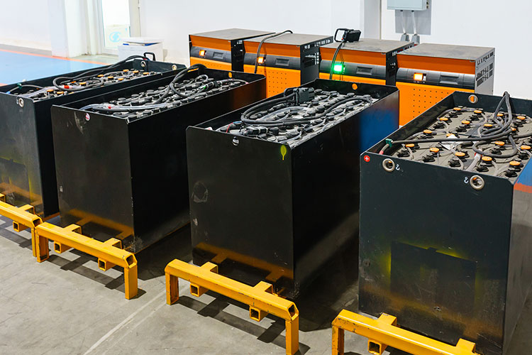 industrial batteries and chargers for forklifts lined up